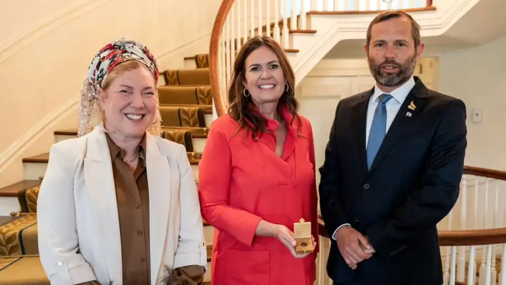 Eliana Passentin, international desk director, Binyamin Regional Council, with Yisrael Ganz and Sarah Huckabee Sanders, June 1, 2026. Photo by Josh Hasten.