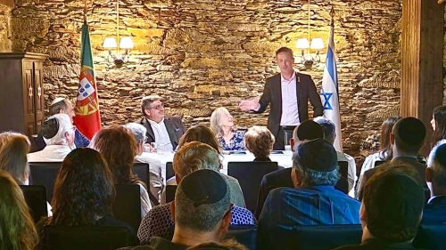 Israeli Ambassador to Portugal Dor Shapira addresses attendees at book release in Oporto, Portugal. Ambassador Manuela Franco (seated middle) and Dr. Luis Campos Ferreira (seated left) look on. Credit: Courtesy.
