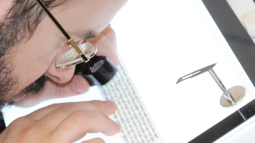 A STAMP-certified expert checks the text of a tefillin. Credit: Courtesy of the Orthodox Union.