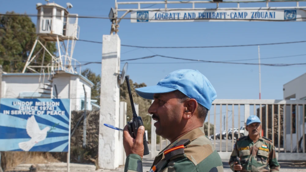 Members of the United Nations Disengagement Observer Force (UNDOF) stand near their post by the Quneitra crossing between Israel and Syria in the Israeli-annexed Golan Heights, on Aug. 30, 2014. U.N. peacekeepers caught up in heavy fighting on the Golan Heights were evacuated, while many of their colleagues were captured by Syrian rebels. Photo by Flash90.