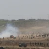 Palestinians burn tires as they protest by the fence on the border between Gaza and Israel, as seen from the Israeli side of the border, June 8, 2018. Photo by Yonatan Sindel/Flash90.