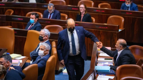 Then-Israeli Prime Minister Naftali Bennett with Ra’am Party head Mansour Abbas during a plenum session and a vote on the state budget at the assembly hall of the Knesset in Jerusalem on Nov. 3, 2021. Photo by Olivier Fitoussi/Flash90.