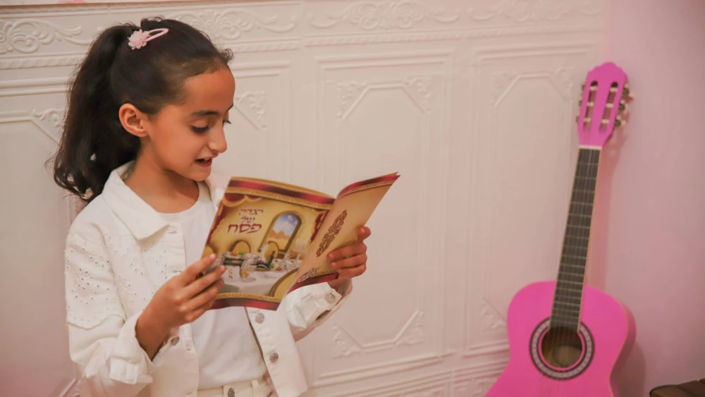 A girl recites the four questions at Passover.