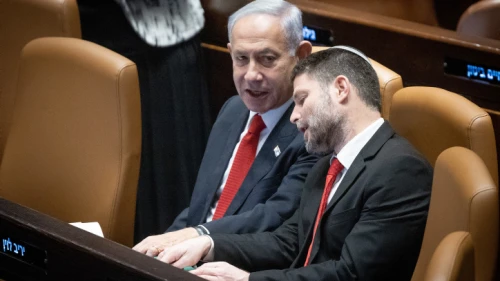 Israeli Prime Minister Benjamin Netanyahu speaks with Israeli Finance Minister Bezalel Smotrich during a discussion and a vote on the government's judicial overhaul plans in the Knesset assembly hall, on Feb. 20, 2023. Photo by Yonatan Sindel/Flash90.