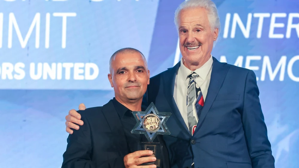 American evangelical pastor Mike Evans presents plumber turned public hero Yaniv Hayoun with an award on October 7, 2026 at a Christian solidarity event in Jerusalem marking three years since the Hamas attack on Israel. Credit: Friends of Zion.