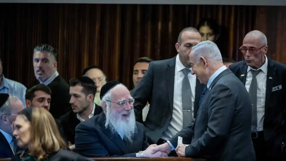 Israeli Prime Minister Benjamin Netanyahu speaks with MK Israel Eichler at the Knesset in Jerusalem, Feb. 19, 2024. Photo by Yonatan Sindel/Flash90.