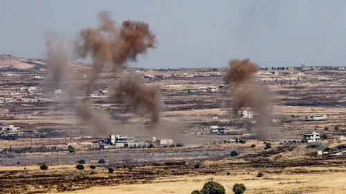 A picture taken from the Israeli side depicts smoke rising near the Israeli-Syrian border in the Golan Heights during fights between the rebels and the Syrian army, June 25, 2017. Photo by Basel Awidat/Flash90.