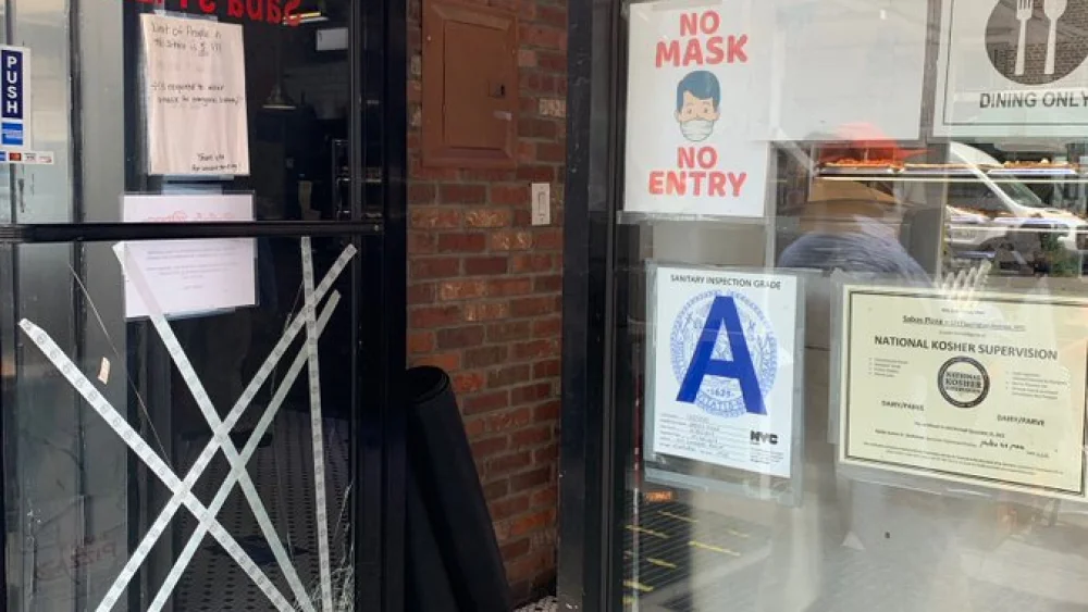 A view of the damaged glass door at Saba's Pizza on New York City's Upper East Side, May 24, 2021. Source: Twitter.