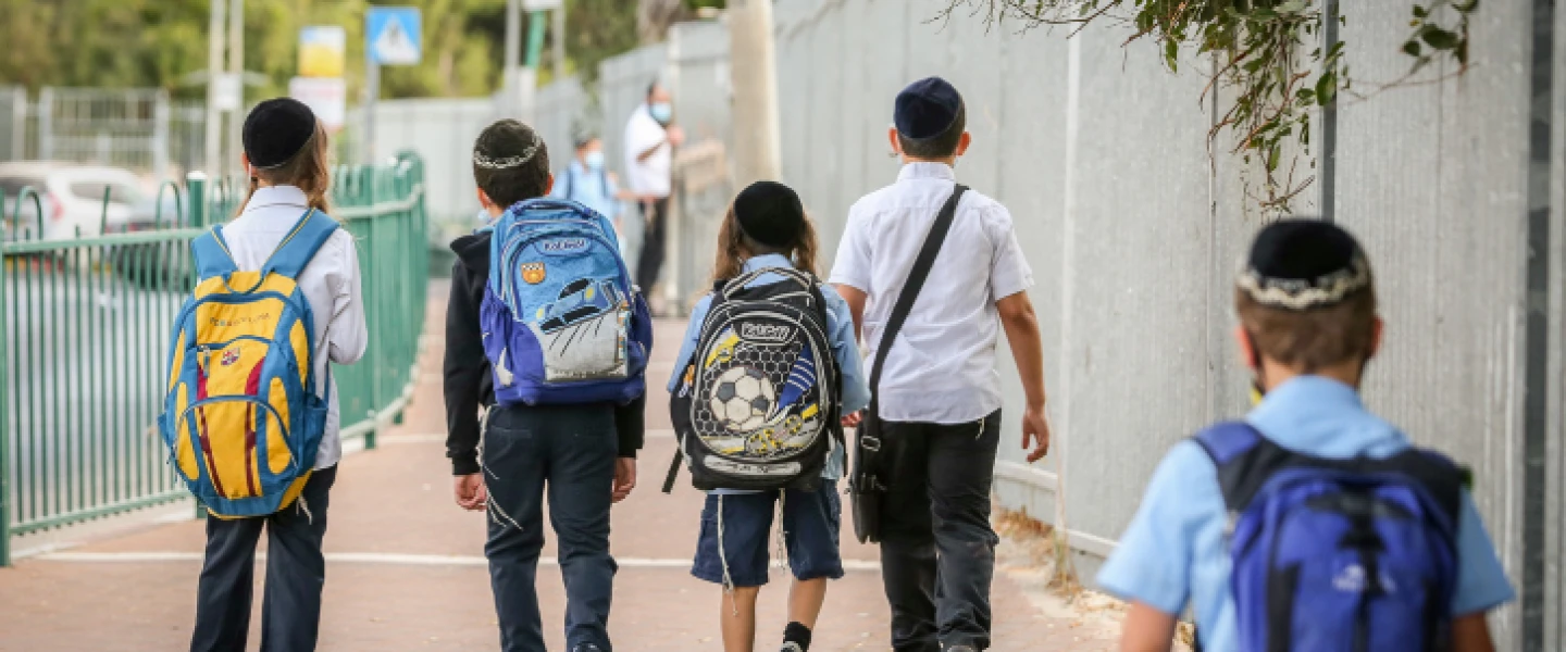 Israeli children wearing face masks make their way to school in Tzfat on their first day back to classes on Nov. 1, 2020. Photo by David Cohen/Flash90.