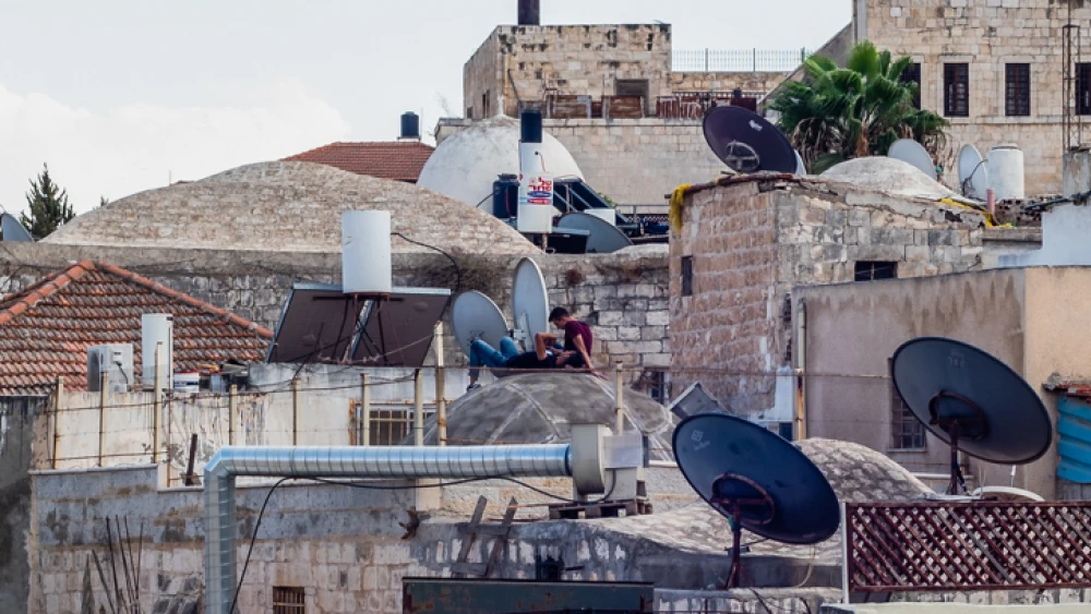 People rest on a rooftop in Jerusalem's Old City on Sept. 7, 2018. Photo by Dario Sanchez/Flash90.