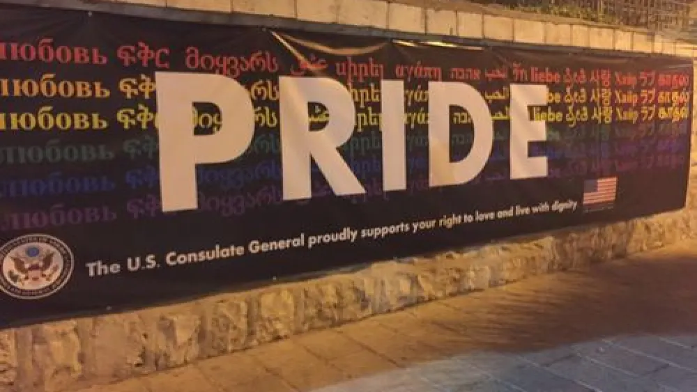 Click photo to download. Caption: During Jerusalem's 2016 gay pride parade, a sign at the American Consulate General reads, “The U.S. Consulate General proudly supports your right to love and live with dignity.” Credit: Eliana Rudee.