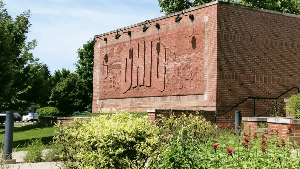 A brick mural wall outside the Baker University Center at Ohio University in Athens, Ohio, June 1, 2024. Credit: Garden Sprite via Wikimedia Commons.