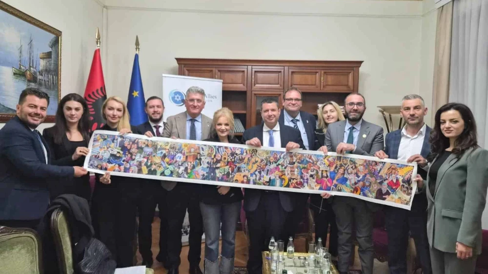 Members of the new Albanian Israel Allies Caucus hold a painting depicting the history of the Jewish people at their inaugural meeting in parliament on Monday. Credit: Courtesy Israel Allies Foundation, November 10. 2025.