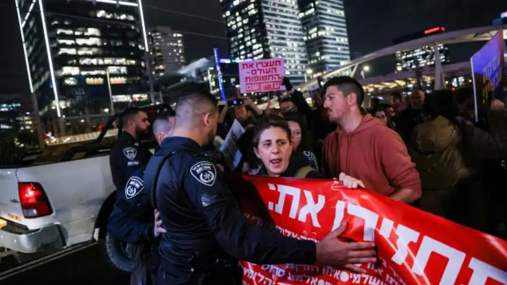 Protesters block the Ayalon Highway in Tel Aviv, calling for the release of Israelis held in Gaza, Jan. 24, 2024. Photo by Chaim Goldberg/Flash90.