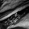 Extricating an oil lamp from a crevice between boulders. Photo by B. Zissu/ Te’omim Cave Archaeological Project.
