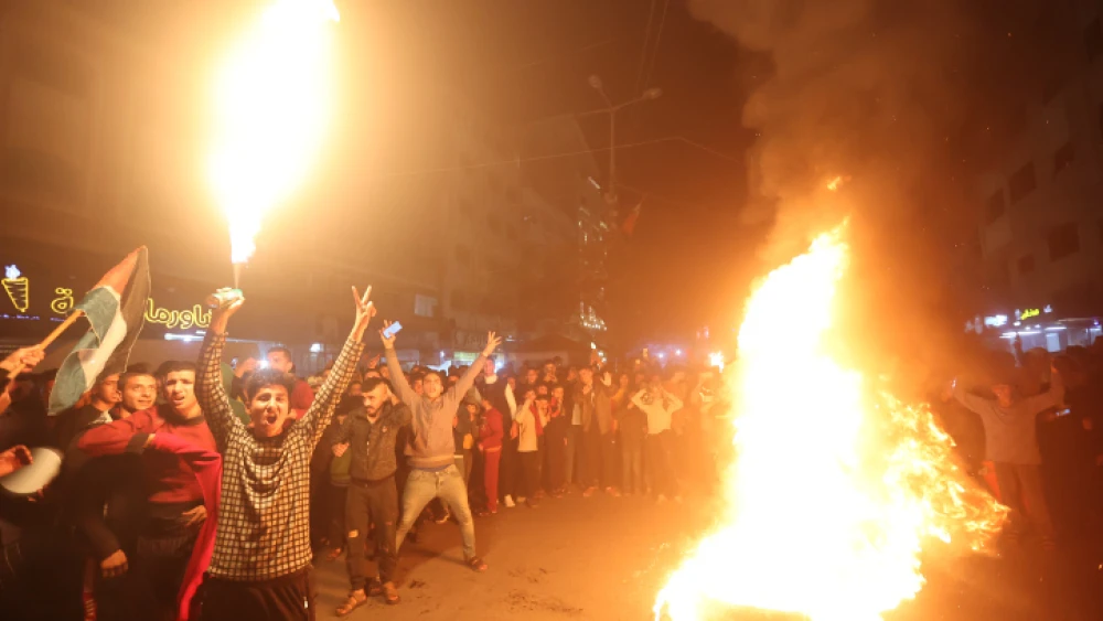 Palestinians celebrate in Gaza City following a terror attack in Jerusalem that left seven Israelis dead, on Jan. 27, 2023. Photo by Atia Mohammed/Flash90.