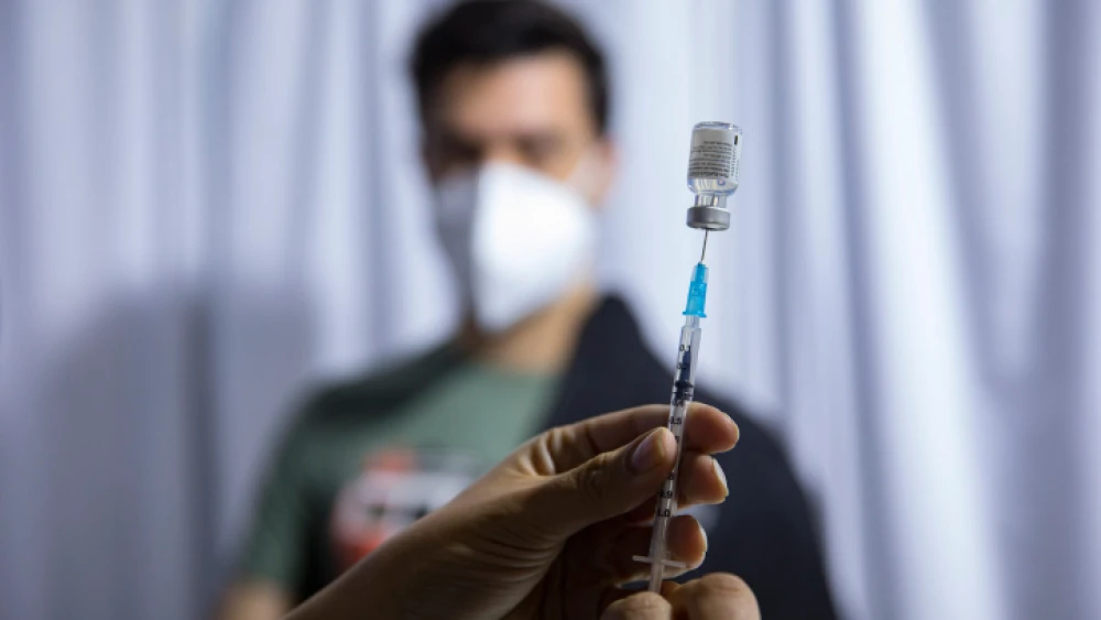 A health worker prepares a dose of Pfizer's BioNTech COVID-19 vaccine at a vaccination center in Jerusalem on Feb. 8, 2021. Photo by Olivier Fitoussi/Flash90.