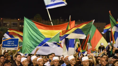 Israeli Druze attend a Druze-led rally to protest against the 'Jewish Nation-State law' in Rabin Square, Tel Aviv on Aug. 04, 2018. Tens of thousands of Israeli Druze and their supporters gathered in Tel Aviv on Saturday night to protest against the 'Jewish Nation-State' law. Photo by Gili Yaari /FLASH90