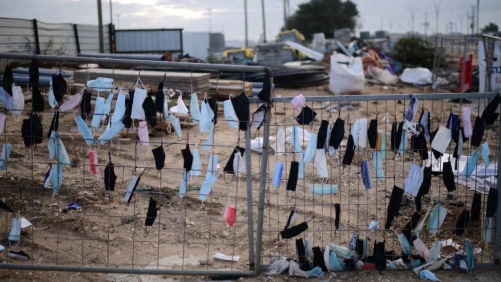 Protective face masks hang on a fence in Glilot, Feb. 14, 2022. Photo by Tomer Neuberg/Flash90.