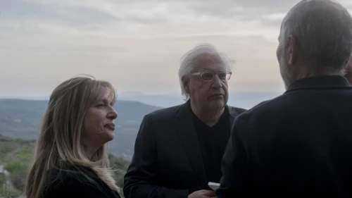 David and Tammy Friedman, facing camera, speak to an attendant of a ceremony held at Ein Kshatot, Israel on March 25, 2025. Photo by Canaan Lidor.