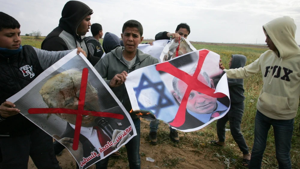 Palestinians demonstrate with posters marring the images of Israeli Prime Minister Benjamin Netanyahu and U.S. President Donald Trump during a protest near Khan Yunis in the southern Gaza Strip on March 30, 2018. Credit: Abed Rahim Khatib/Flash90