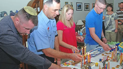 Click photo to download. Caption: U.S. Navy personnel light Hanukkah candles on Dec. 28, 2008, in Guantanamo Bay, Cuba. Credit: U.S. Navy photo by Mass Communication Specialist 1st Class Richard M. Wolff.