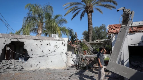 A man stands outside a house that was hit by a rocket fired from the Gaza Strip in the southern Israeli city of Ashkelon, on November 13, 2018. Photo by Nati Shohat/Flash90