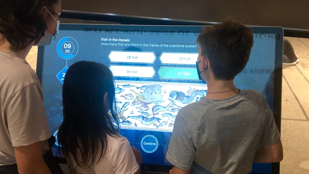 Grandchildren of donor Shelby White try out the interactive multimedia section