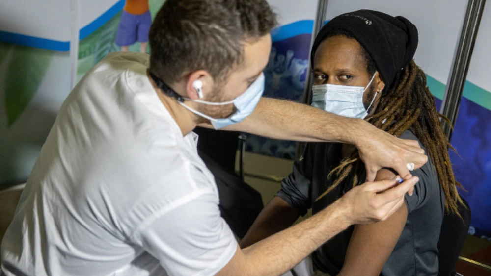 A COVID-19 vaccine is administered at a vaccination center in Jerusalem on March 11, 2021. Photo by Yonatan Sindel/Flash90.