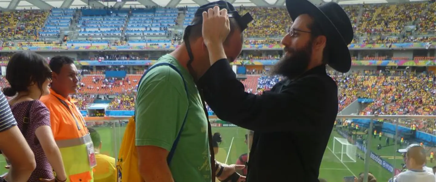 Among the thousands of Jewish fans traveling to the World Cup will be many Westerners and Israelis who have never been to Russia. Chabad centers around the country are preparing to welcome them and encourage them to explore all aspects of Jewish life, as Chabad representatives did four years ago at the World Cup games in Brazil, above. (Chabad.org)