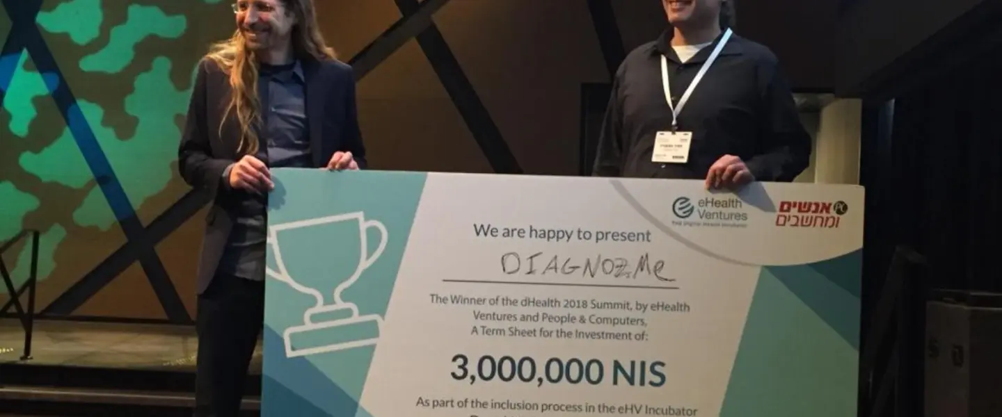Diagnoz.me founders Ariel Livne and Tamir Epstein accepting their NIS 3 million (nearly $830,000) prize money at the dHealth 2018 Summit. Credit: Courtesy of Israel21c.