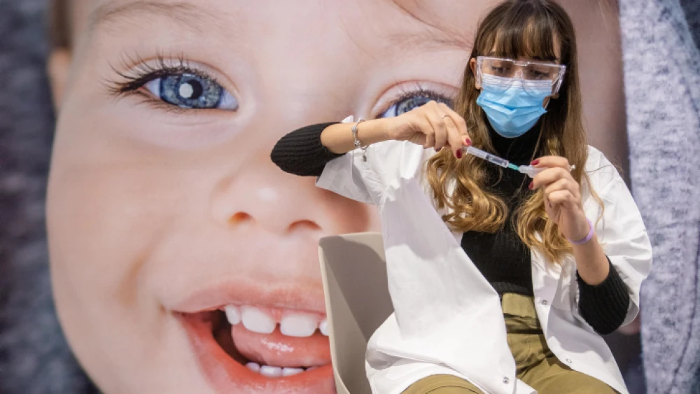A medical worker prepares a COVID-19 vaccine injection at the Meuhedet vaccination center in Jerusalem on Jan. 13, 2021. Photo by Yonatan Sindel/Flash90.