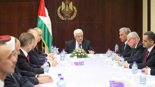 Palestinian Authority leader Mahmoud Abbas (center) meets with the new Fatah-Hamas unity government in the West Bank city of Ramallah on June 2, 2014. Credit: Issam Rimawi/Flash90.