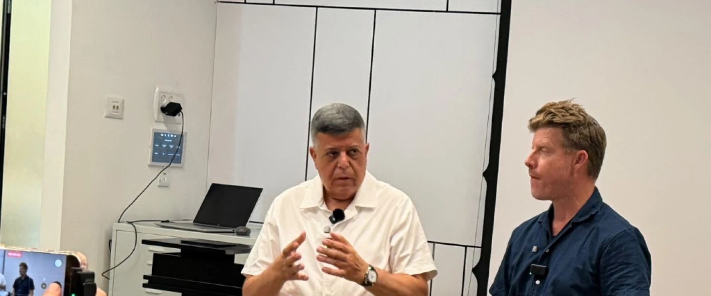 Ofakim Mayor Mayor Itzik Danino (left) with an interpreter at a press conference in the southern Israeli city on Oct. 6, 2026. Photo by Brett Goodman/TPS-IL
