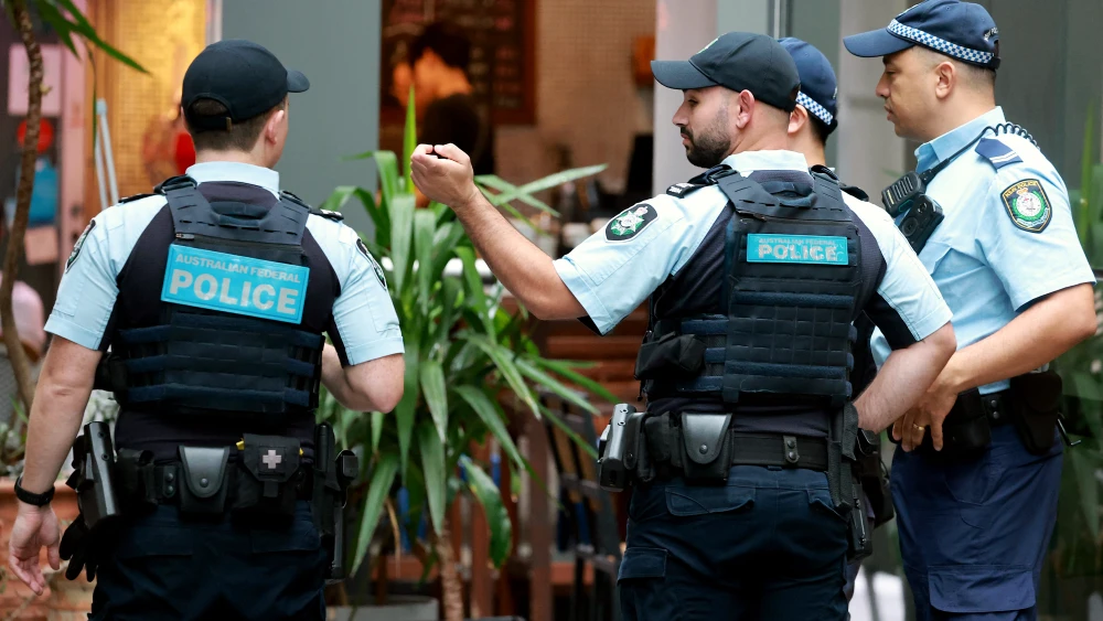 Australian Federal Police (AFP) officers and New South Wales police officers stand outside the venue of the Royal Commission on Antisemitism and Social Cohesion in Sydney on May 25, 2026. Photo by David Gray / AFP via Getty Images.