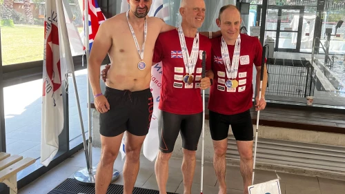 Craig Lundberg (right) receives a swimming medal in the visually impaired category. Courtesy.