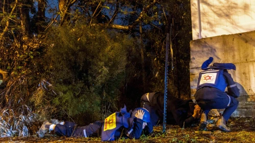 People take cover as siren warns of incoming missile fired from Yemen, near Rehovot, Dec. 30, 2024. Photo by Yossi Aloni/Flash90.