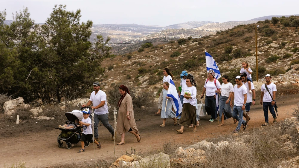 Jewish families take part in a march between the former settlements of Ganim and Kadim in the West Bank, which were evacuated as part of Israel’s 2005 disengagement plan, during the Jewish holiday of Sukkot, Sept. 30, 2026. Photo by Hilel Ben Or/Flash90