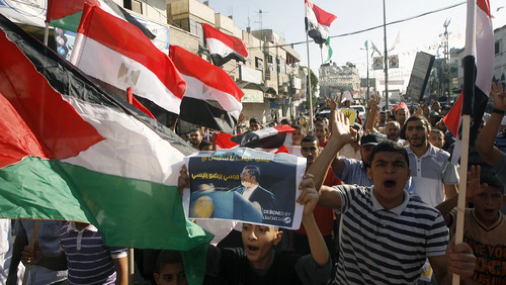 Palestinians gather during a demonstration in support of ousted Egyptian President Mohamed Morsi in the Hamas-controlled southern Gaza Strip town of Rafah on August 23, 2013. The removal of Morsi—a president from Hamas's parent group, the Muslim Brotherhood—creates "serious problems for Hamas," Matthew Levitt of the Washington Institute for Near East Policy said. Credit: Abed Rahim Khatib/Flash 90.