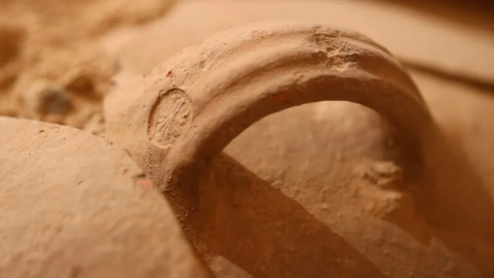 A jar handle with a rosette impression associated with the royal economy in the Kingdom of Judah. Photo by Eliyahu Yanai/City of David.