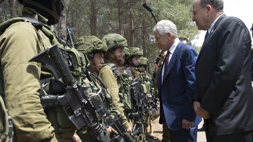 U.S. Secretary of Defense Chuck Hagel and Israeli Minister of Defense Moshe Ya'alon (right) speak with members of the K-9 Special Forces Unit at Camp Adam in Israel on April 23, 2013. Credit: Secretary of Defense.