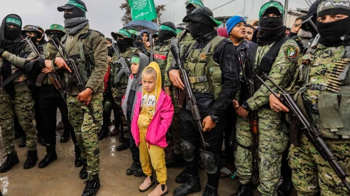Members of the Al-Qassam Brigades hand over Israeli hostages to the Red Cross, as part of the ceasefire agreement between Israel and Hamas, in Rafah, Feb. 22, 2025. Photo by Abed Rahim Khatib/Flash90.