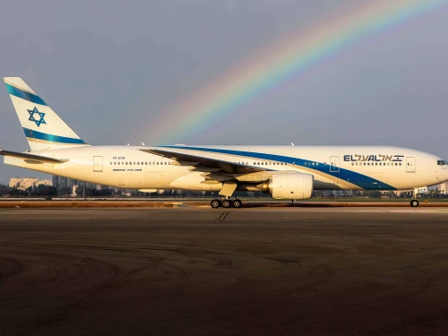 An El Al plane on the runway of Ben-Gurion International Airport with a rainbow in the background. Credit: Courtesy.