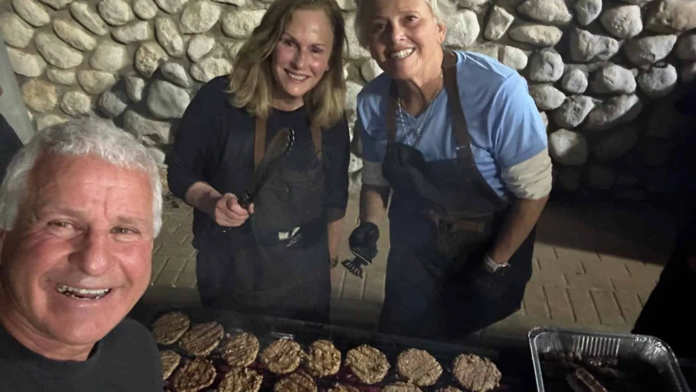 Robert Freibaum, Sue Maltiel and another volunteer barbecue on an IDF base, October 2025. Credit: Robert Freibaum.
