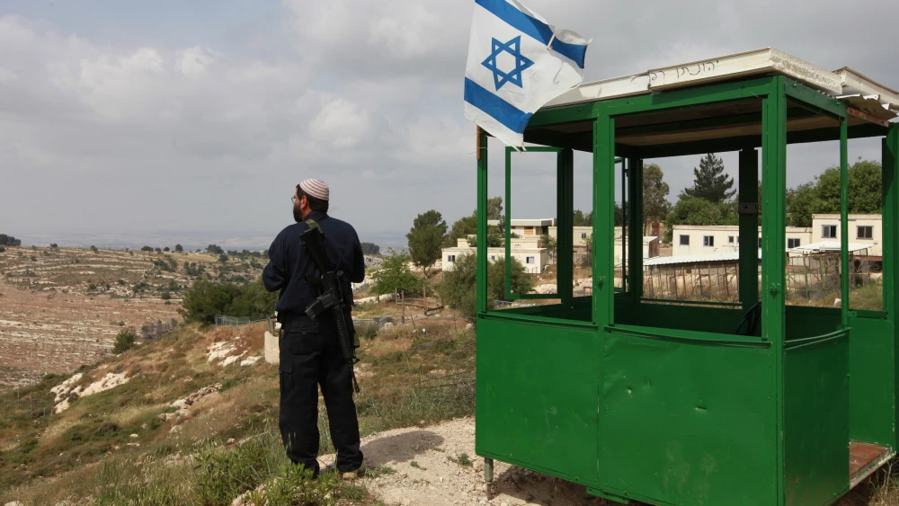 An Israeli security guard at his post at the Bat Ain settlement in Gush Etzion. Credit: Nati Shohat/Flash90.