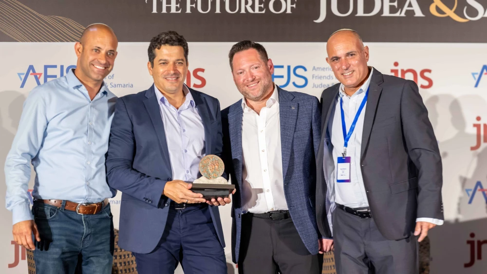 Yigal Dilmoni,r., and Rafi Lazerowitz, 2nd from r., present Diaspora Affairs Minister Amichai Chikli with an award of appreciation at "The Future of Judea and Samaria" conference, Jerusalem, Oct. 29, 2025. Photo by Matt Kaminsky/JNS.