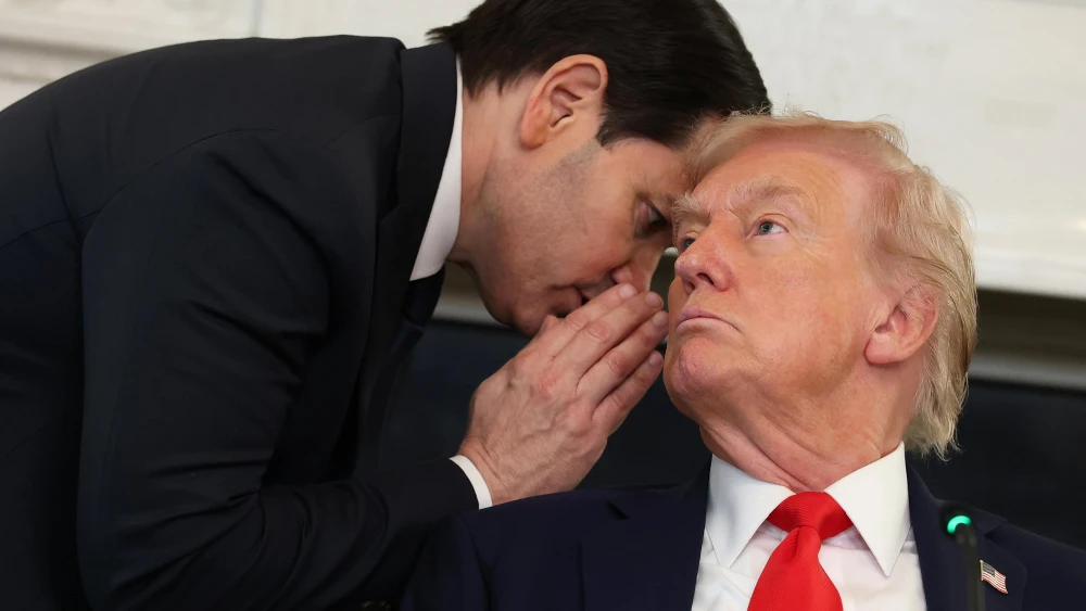 U.S. Secretary of State Marco Rubio speaks to U.S. President Donald Trump during a roundtable discussion in the State Dining Room of the White House in Washington, D.C., on Oct. 8, 2025. Photo by Anna Moneymaker/Getty Images.