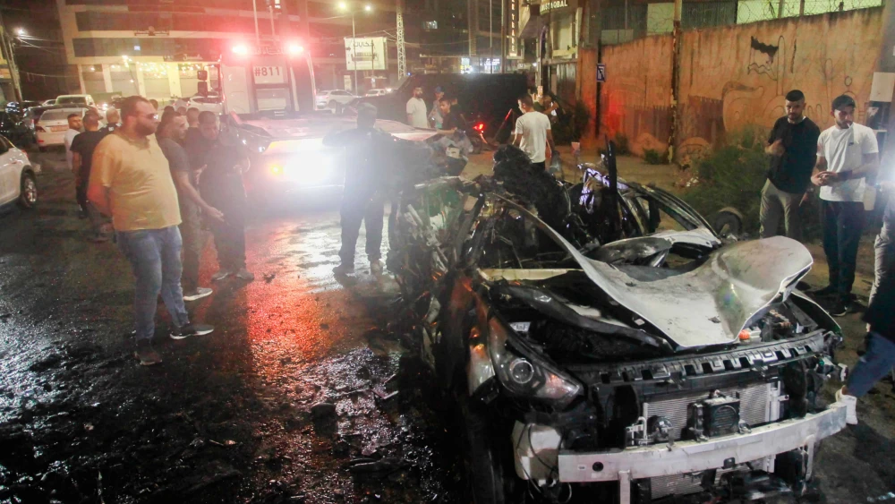 Palestinians next to a car that was hit by an Israeli airstrike, in the Samaria city of Jenin, Aug. 17, 2024. Photo by Nasser Ishtayeh/Flash90.