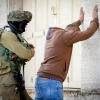An Israeli soldier performs a body search on a Palestinian man in Hebron, Nov. 4, 2016. Photo by Wisam Hashlamoun/Flash90.