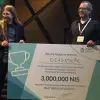 Diagnoz.me founders Ariel Livne and Tamir Epstein accepting their NIS 3 million (nearly $830,000) prize money at the dHealth 2018 Summit. Credit: Courtesy of Israel21c.